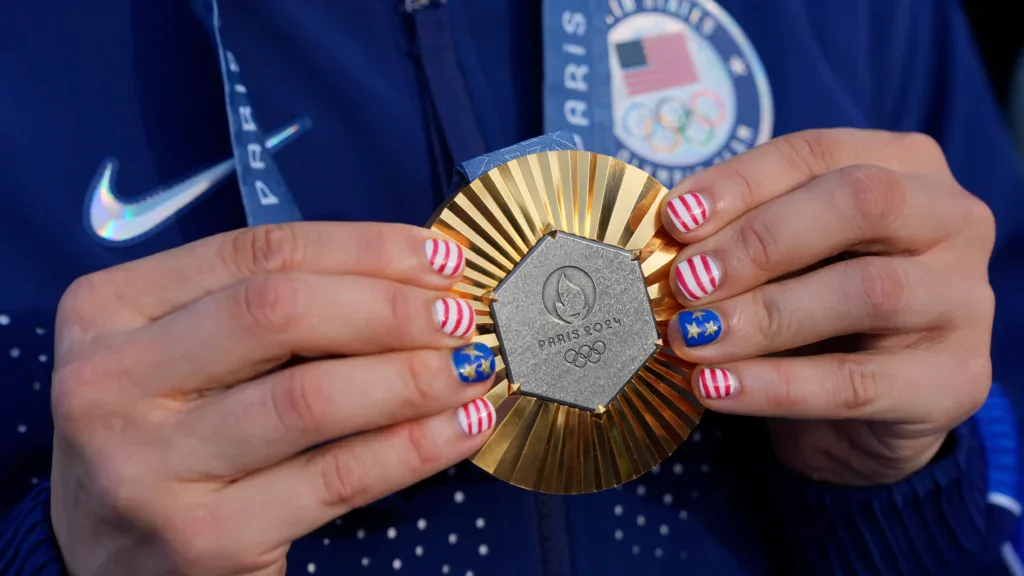 Someone holding an Olympic medal
