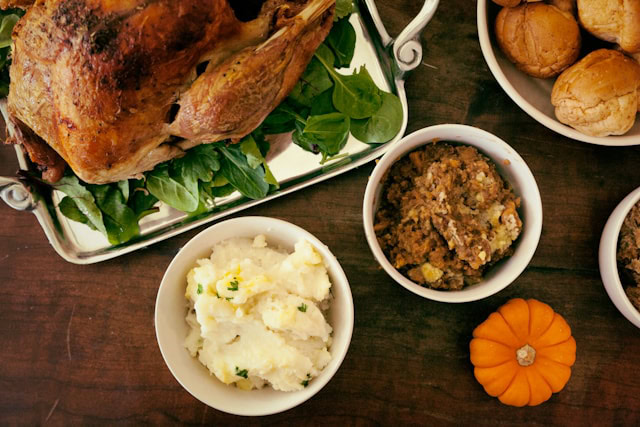 Different Thanksgiving Sides spread out on a table