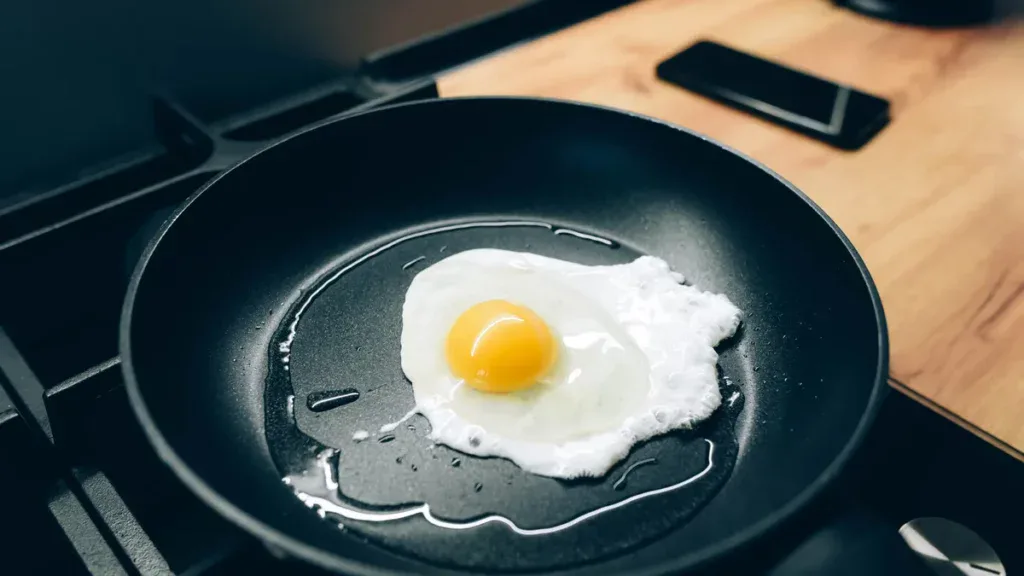 An egg being cooked on a pan