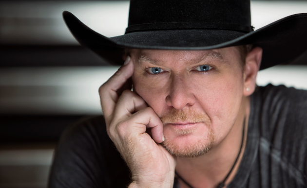 Jax Country 100.3 radio personality with cowboy hat, close-up portrait.
