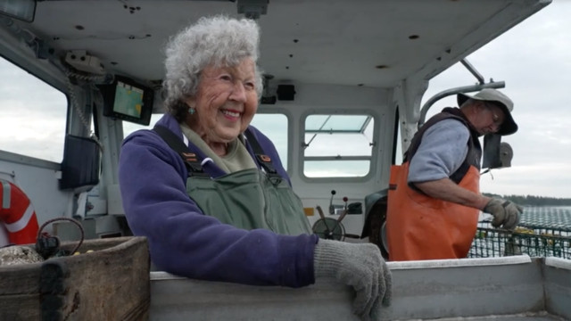 An older ,lady on a lobster boat